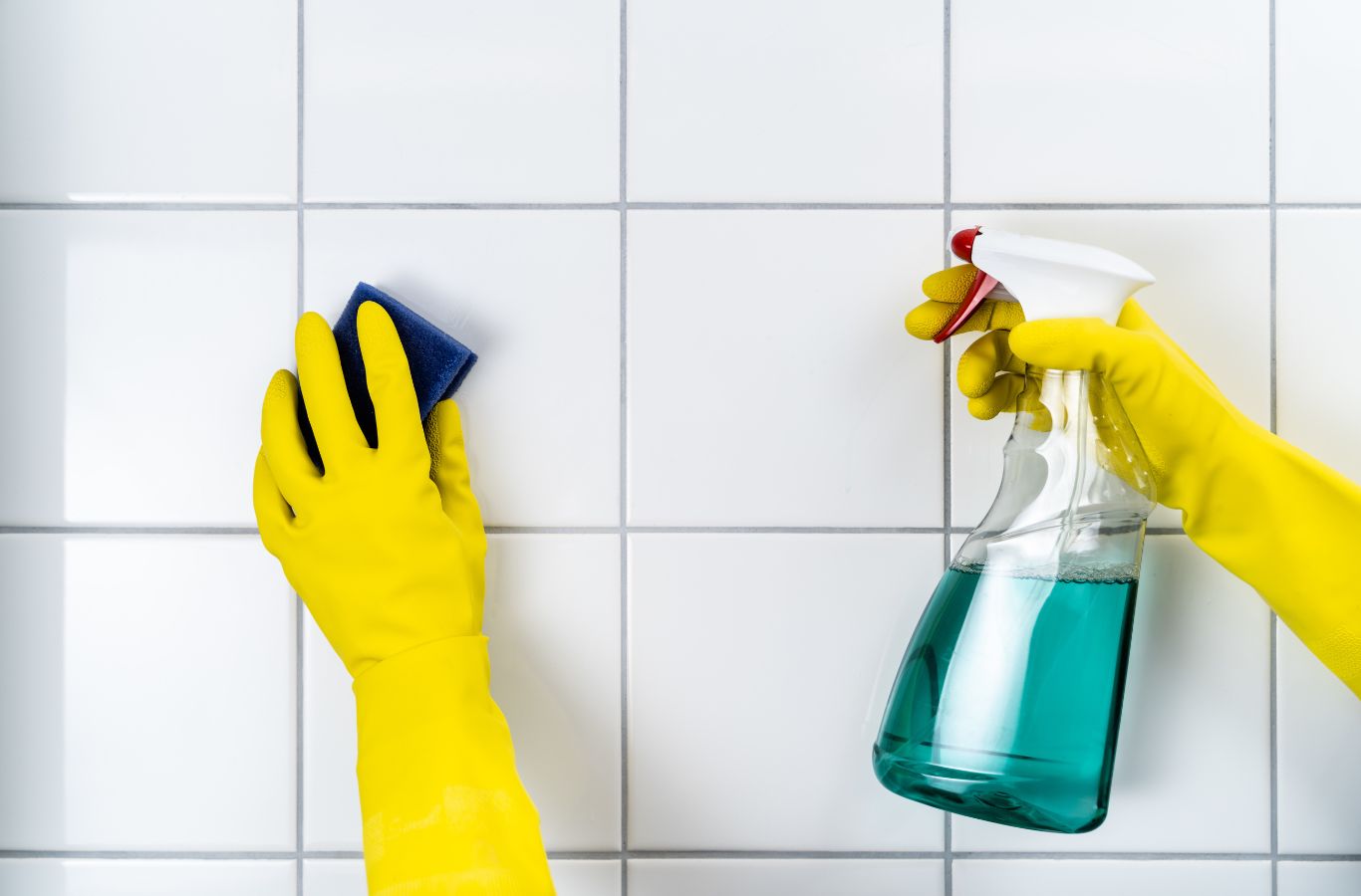 QBM Services team member performing deep cleaning of tile and grout in a Northern Utah kitchen, removing dirt and stains.